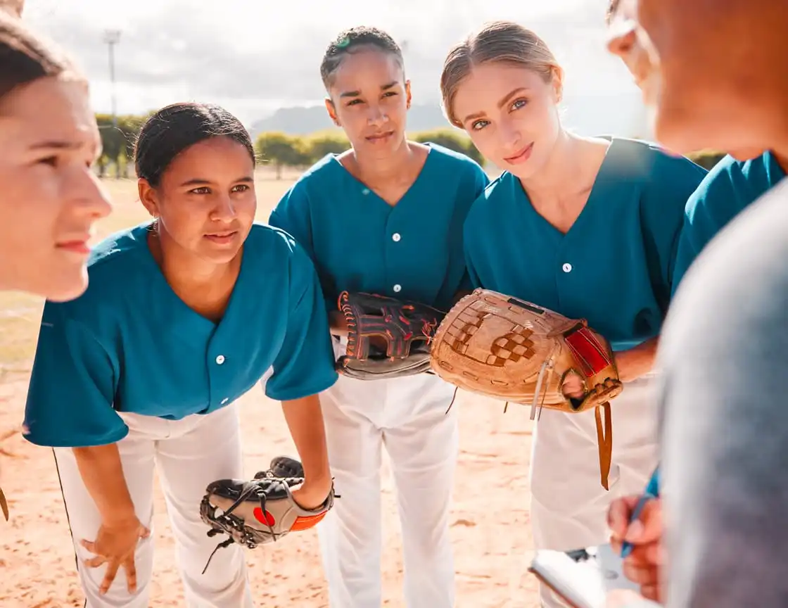 A group of adult women on a softball team.