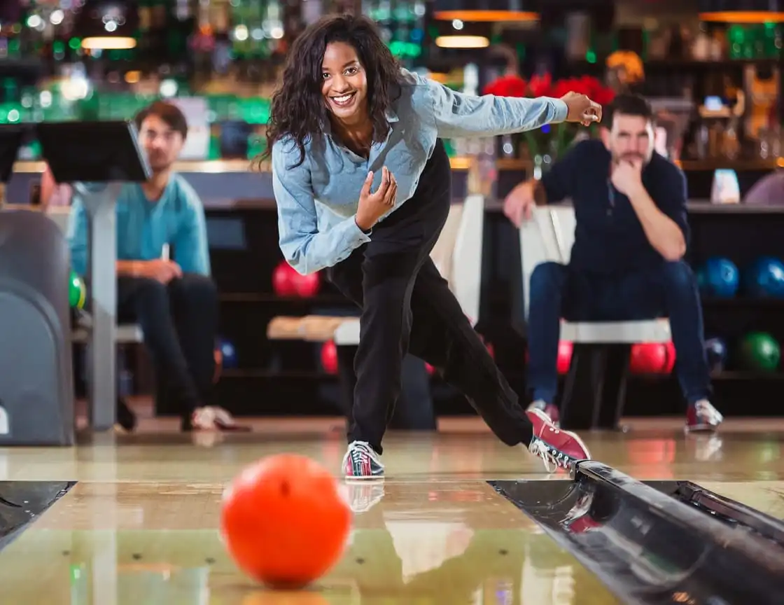 A group of men and women bowling on a team.