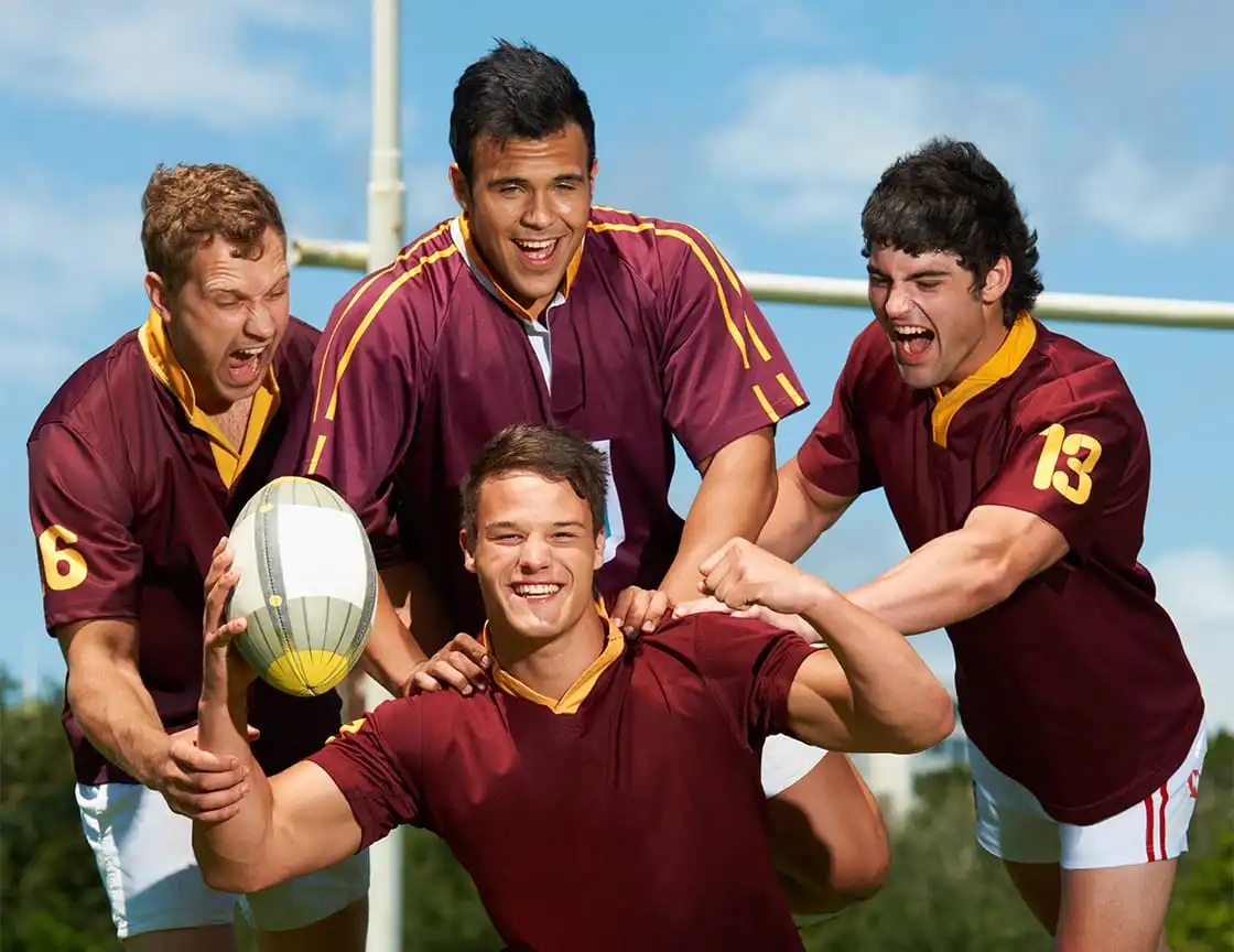 A group of men playing rugby on a team.