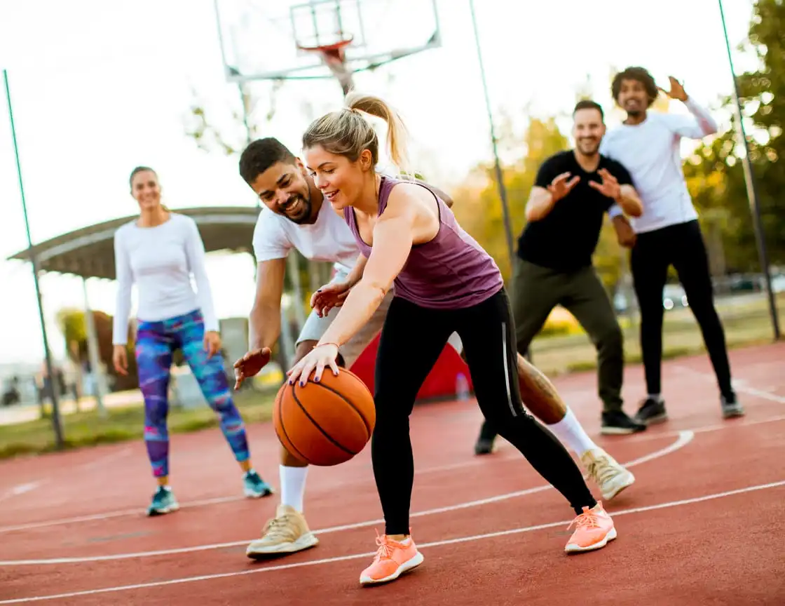 A group of adult men and women on a basketball team.