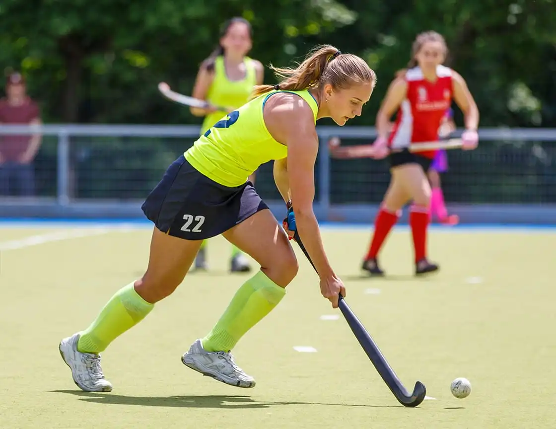 A group of adult women on a field hockey team.