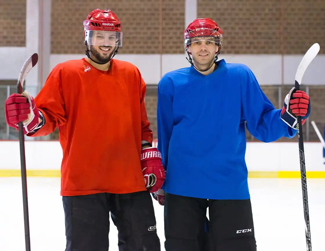 A group of adult men on a hockey team.